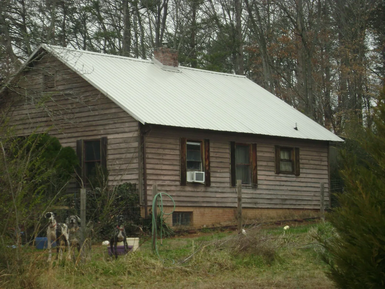 White metal roof on an old wood sided farmhouse, from a Metal Roof Installation job in Sneedville